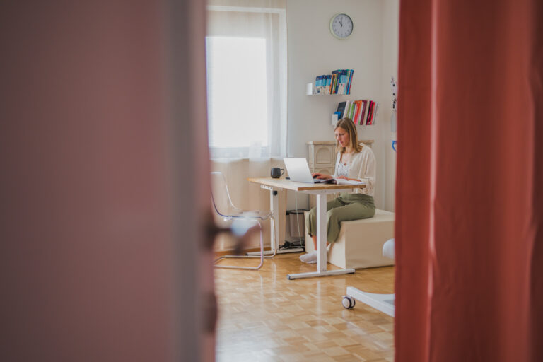 Frau am Schreibtisch bei Recherche – Businessfotografie Graz und Umgebung, authentische Arbeitsmomente