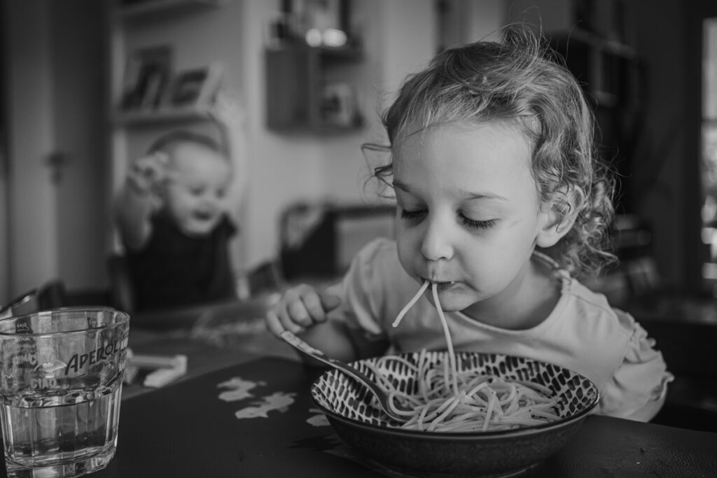 Mädchen isst Spaghetti – natürliche Familienfotos Graz und Umgebung, authentische Alltagsszenen