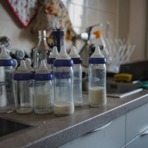 einige halmvolle Babyflaschen stehen in der Küche. authentische Newbornfotografie Graz